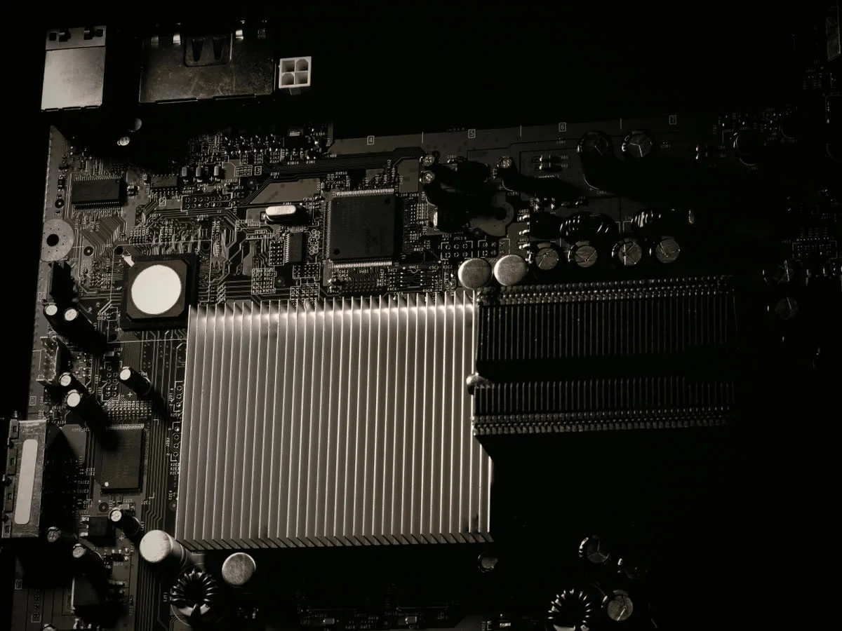Computer motherboard with heatsink on a repair bench